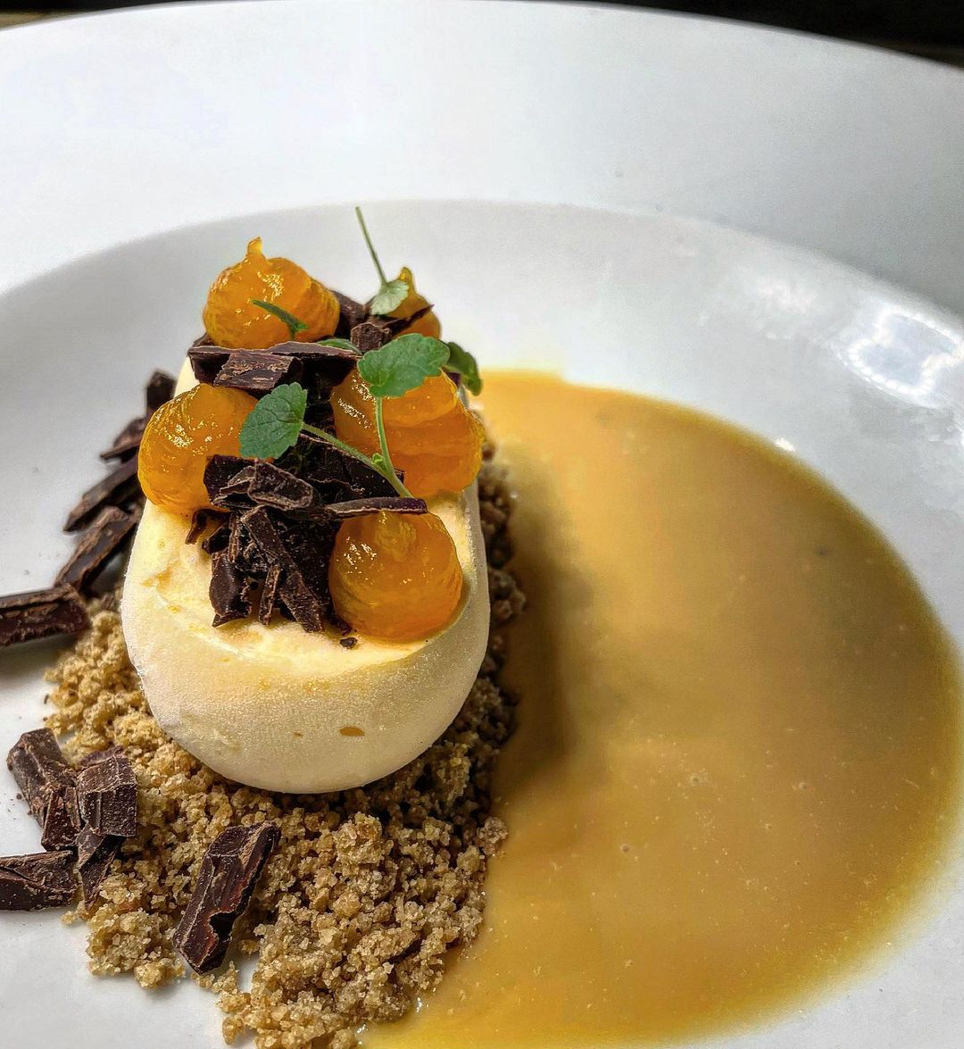 A dessert at Momenti, made from pumpkin semifreddo, cardamom crumble, salted caramel sauce and chilli flakes and chocolate. 