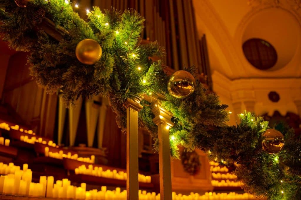 A staircase decorated for a Candlelight Christmas concert.