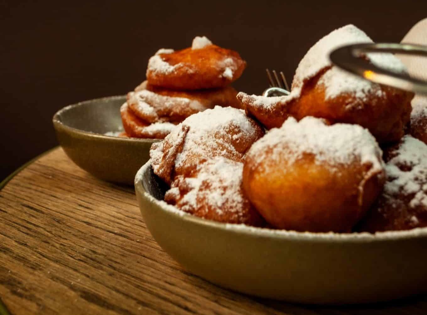 Two bowls of traditional oliebollen.
