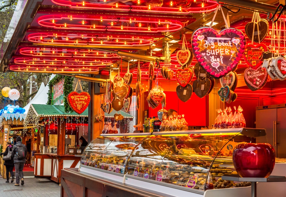 A red stall at a Christmas market in Amsterdam selling baked goods.