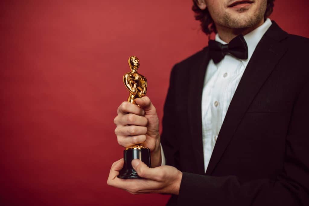Man holding Academy Awards statute