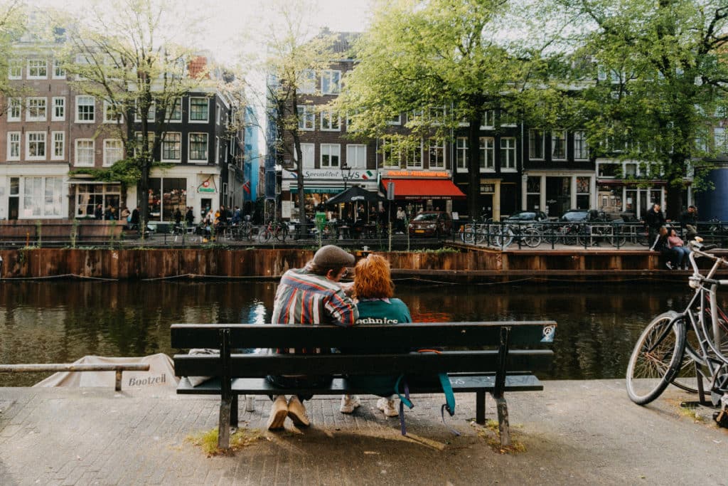 couple sitting on a bech: date ideas in amsterdam
