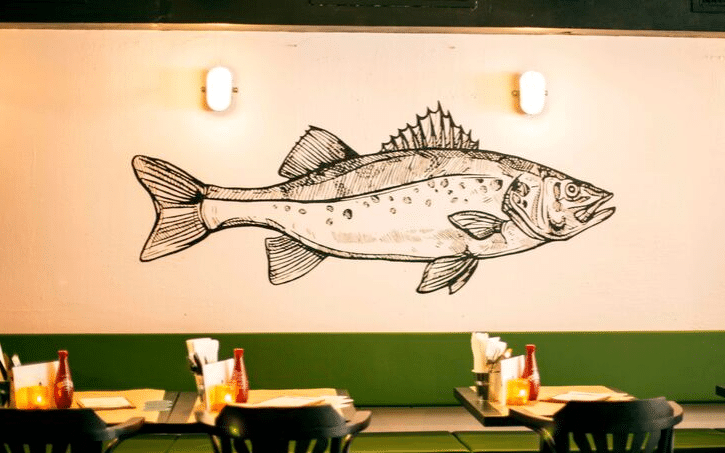 Fish mural and seating at The Good Companion in Amsterdam